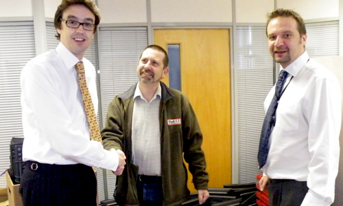 Paul Guest Chair of MAK receiving computers from Chris Davis of Moneyplus Group and company IT Manager Andrew McKenzie